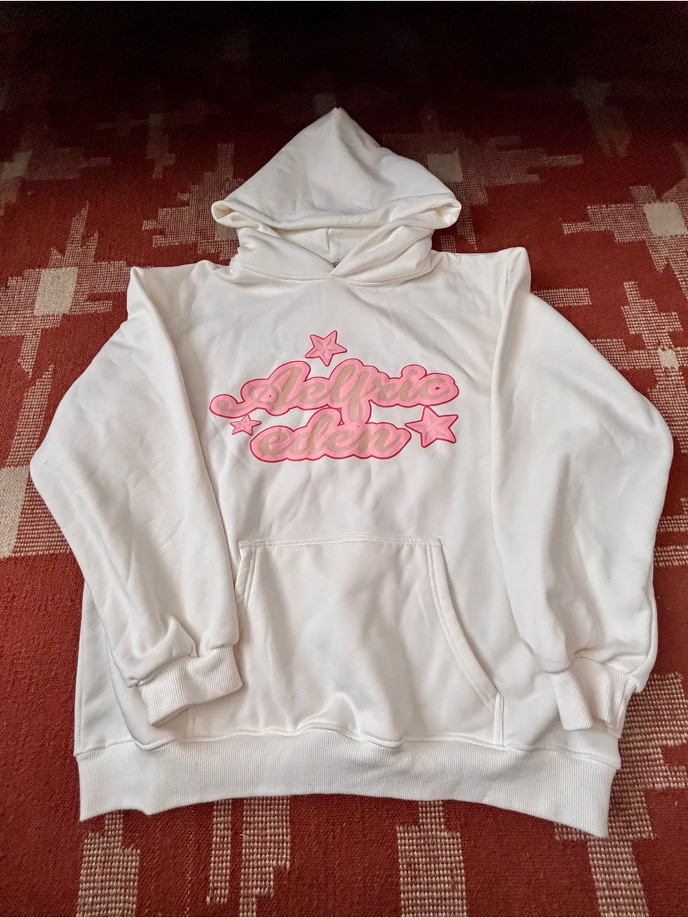 Aelfric Eden white Pullover Hoodie with pink logo.